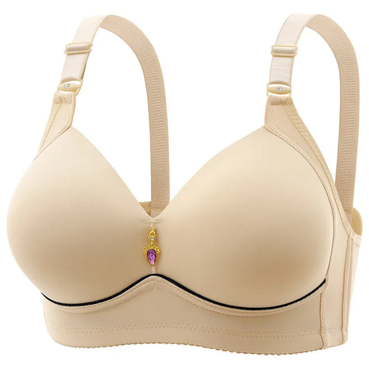 A beige, wire-free, thin cup bra with a heart charm on the clasp.