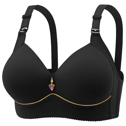 A beige, wire-free, thin cup bra with a heart charm on the clasp.